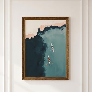 Gold-framed vintage lake print, aerial teal-blue water with tiny rowers, lake house wall art