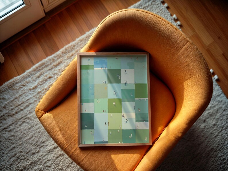 a framed collage of small square images arranged in a grid-like pattern, resting on an orange chair.