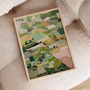 The image is a framed collage depicting a vibrant, colorful landscape with various elements such as trees, buildings, and fields.