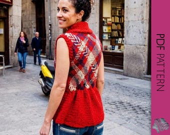 May include: A red knitted vest with a geometric pattern in shades of blue, cream, and burgundy. The vest has a high collar and a peplum-style hem. The image also includes a woman wearing the vest, blue jeans, and a city street background.