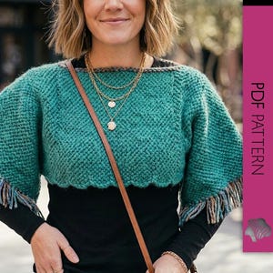 May include: A teal green knitted bolero with fringed sleeves. The bolero has a textured stitch pattern and a scalloped hemline. The sleeves are trimmed with a fringe of mixed-color yarn. The text "PDF PATTERN" is visible on the right side of the image.