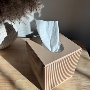 One beige ribbed tissue box cover