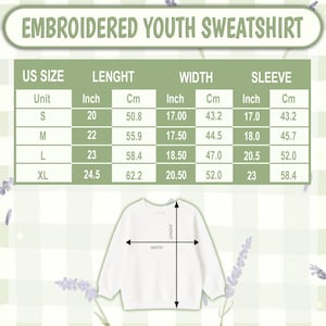 May include: A size chart for an embroidered youth sweatshirt with a table displaying US sizes S, M, L, and XL. The chart lists length, width, and sleeve measurements in both inches and centimeters, accompanied by a diagram of a white sweatshirt.