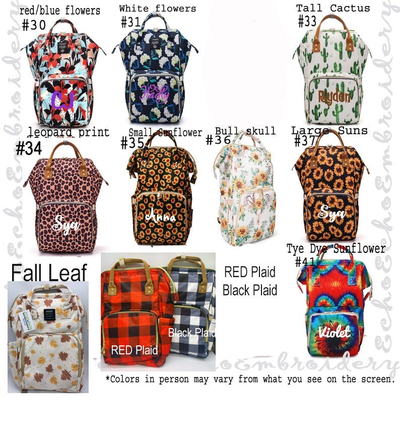 May include: Ten different styles of diaper bags with various patterns and colors. The bags are all backpacks with a large main compartment and multiple pockets. The patterns include red and blue flowers, white flowers, tall cactus, leopard print, small sunflower, bull skull, large suns, fall leaf, red plaid, black plaid, and tie dye sunflower. The bags are all personalized with names.