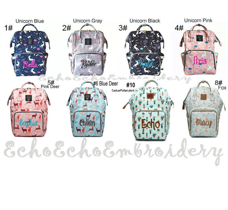 May include: Ten different diaper bags with various patterns and colors. The bags are numbered 1 through 10 and each has a different name embroidered on the front. The patterns include unicorns, deer, cacti, and foxes.
