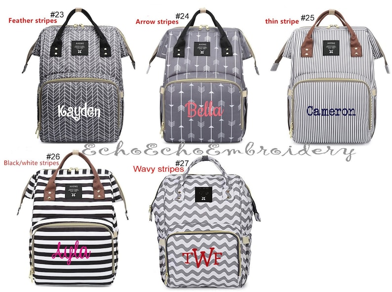 May include: Ten different diaper bags with various stripe patterns, including feather, arrow, thin, black and white, and wavy stripes. Each bag has a personalized name embroidered on the front.