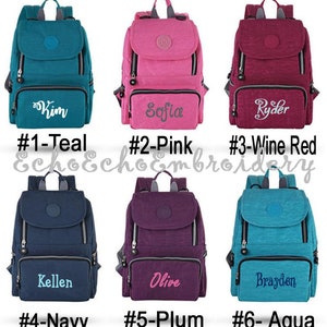 May include: Six different colored nylon backpacks with personalized embroidery. The backpacks are teal, pink, wine red, navy, plum, and aqua. The embroidery reads "Kim", "Sofia", "Ryder", "Kellen", "Olive", and "Brayden".