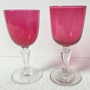 Two Victorian matching hand blown cranberry wine glasses