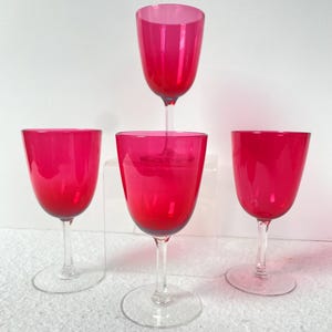Four Victorian matching hand blown cranberry wine glasses