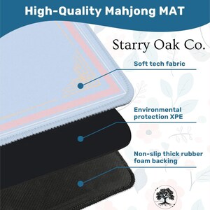 May include: A layered Mahjong mat with a light blue top layer, a black middle layer, and a textured black bottom layer. The mat features the text "High-Quality Mahjong MAT" and "Starry Oak Co." with details about the fabric and backing.