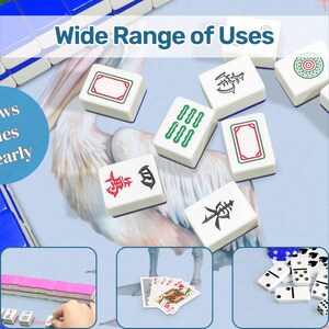 May include: A collection of white Mahjong tiles with various symbols and designs, including red, green, and black markings. The image also shows playing cards and dominoes, with the text "Wide Range of Uses" and "Shows Tiles Clearly".