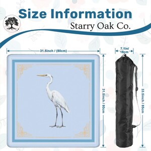 May include: A square, light blue mat with a white heron illustration and gold trim, measuring 31.5 inches (80 cm) on each side. Includes a black carrying bag, 33.5 inches (85 cm) long and 7.1 inches (18 cm) wide. The text "Size Information" and "Starry Oak Co." are visible.