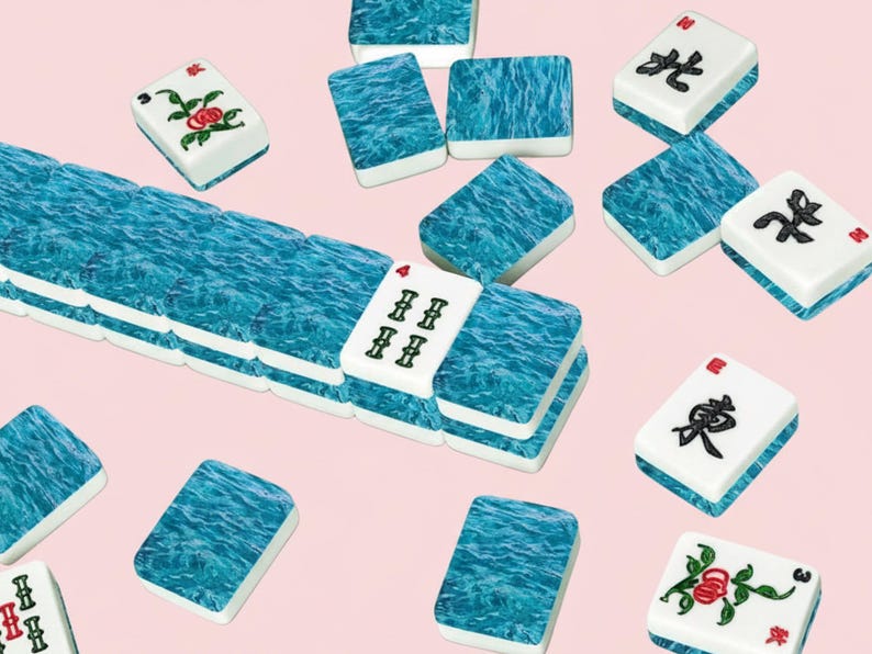 May include: A collection of Mahjong tiles with a blue water-like design and white tiles with red and black symbols and floral patterns. The tiles are scattered on a light pink background.
