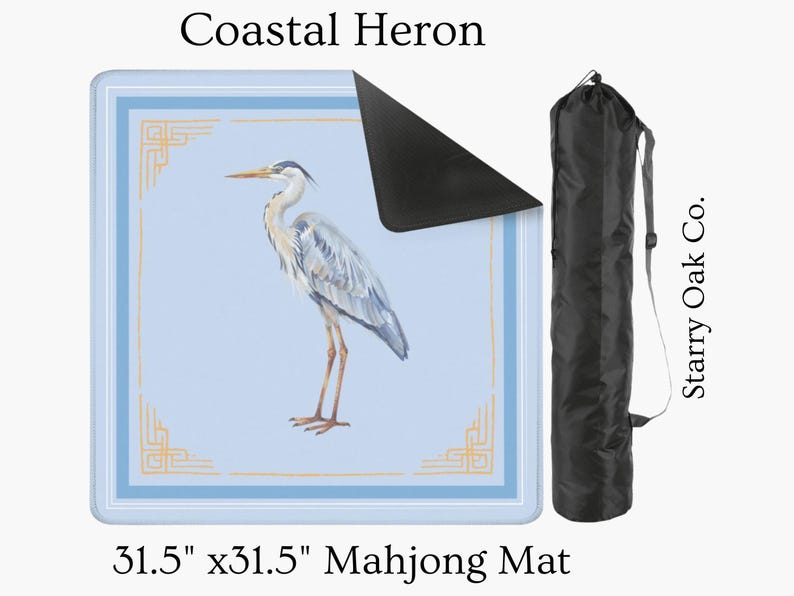 May include: A 31.5" x 31.5" Mahjong mat featuring a watercolor illustration of a Coastal Heron. The mat has a light blue background with a decorative border and a black carrying case. Text on the mat reads "Coastal Heron".