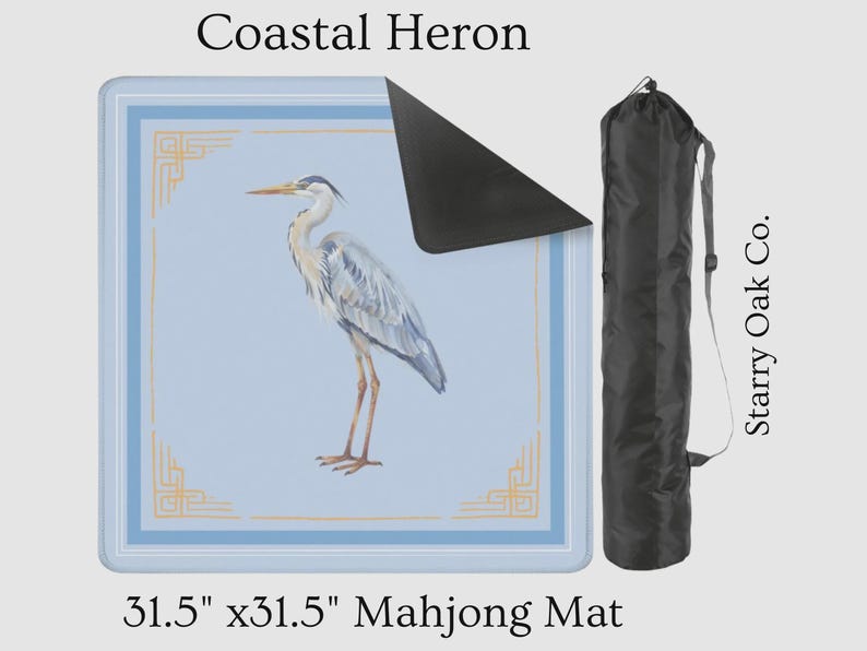 May include: A 31.5" x 31.5" Mahjong mat featuring a watercolor illustration of a Coastal Heron. The mat has a light blue background with a decorative border and a black carrying case. The text "Coastal Heron" is at the top.