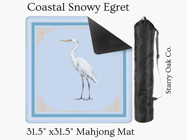 May include: A 31.5" x 31.5" Mahjong mat featuring a Coastal Snowy Egret illustration. The mat has a light blue background with a white and gold border. A black carrying case is included. Text on the mat reads "Coastal Snowy Egret".