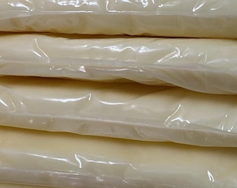 May include: A stack of individually wrapped, white, rectangular blocks of cheese.