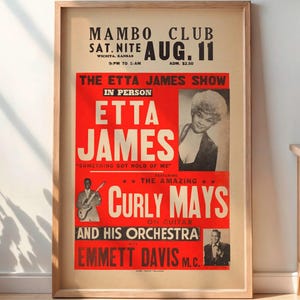 May include: A framed vintage poster advertising the Etta James Show at the Mambo Club on August 11th. The poster features a red and cream color scheme with images of Etta James, Curly Mays, and Emmett Davis.