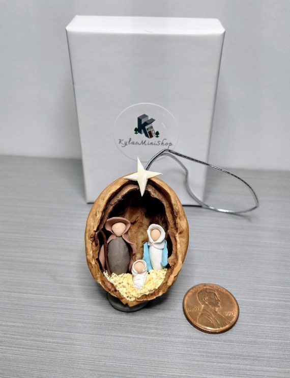 An entire clay Nativity scene sculpted inside a walnut shell — impossibly tiny, impossibly charming, with 201 favorites proving real demand.