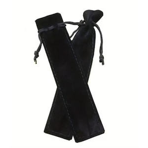 May include: Two black velvet pen pouches with drawstring closures. The pouches are rectangular with a stitched seam down the center. The drawstrings are black and knotted at the ends. The pouches are displayed against a white background.