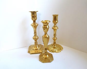 Vintage trio of brass candle holders various sizes