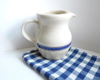 Vintage pottery jug with hand painted stripe