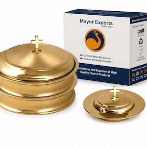 May include: A set of gold-colored stainless steel communion ware including a stack of three lidded bowls and one smaller lidded bowl, each topped with a cross finial. The items are displayed next to a white box labeled Mayur Exports.