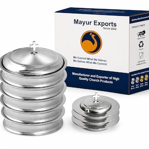 May include: A set of silver-coloured stainless steel communion trays stacked in two columns, each topped with a small cross. The items are displayed next to a white and blue product box labelled Mayur Exports with a peacock logo and text.