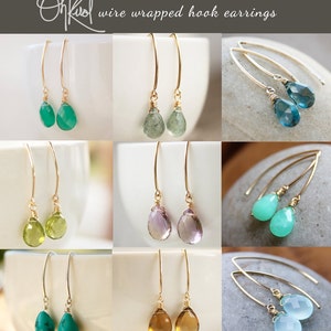 May include: A collection of wire wrapped hook earrings featuring various gemstone drops, including green, blue, purple, and brown.  OhKool wire wrapped hook earrings.