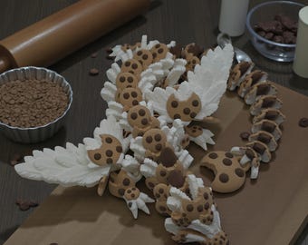 May include: A whimsical, edible dragon sculpture made of cookies and cream, with chocolate chip accents. The dragon is arranged on a wooden cutting board, with a rolling pin and chocolate sprinkles in the background. A creative and delicious dessert.