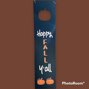 Wood plaque, vinyl lettering, “Happy Fall Y’all” with pumpkins and pumpkin cutout.