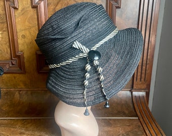 1920s original black wide brim straw cloche with black and white striped silk trim. New Old Stock, 21.5" women’s small