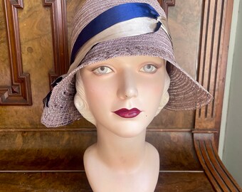 Original 1920s delightful natural straw wide brim cloche in grey/lilac with blue and white satin trim, 22” medium head NOS