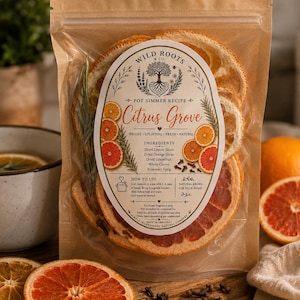 May include: A clear resealable pouch containing a pot simmer recipe labeled Wild Roots & Co. Citrus Grove. The contents include dried orange slices, dried grapefruit slices, dried lemon slices, whole cloves, and a rosemary sprig for home fragrance.