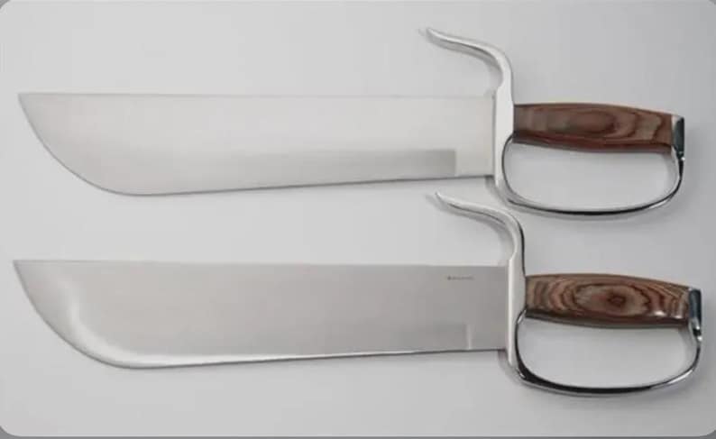 May include: Two stainless steel butterfly swords with wooden handles and finger loops. The blades are rectangular with a curved edge. The handles are a dark brown wood grain. The finger loops are a shiny silver color.