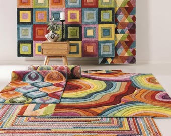 May include: A collection of multi-colored area rugs featuring various geometric patterns including squares, concentric circles, and linear stripes. The rugs display a vibrant palette of red, orange, yellow, green, blue, and purple hues throughout.