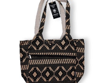 May include: Black and tan tote bag with a geometric pattern. The bag has a zippered pocket and sturdy handles. The tag reads "Wandre Muse Natural Bag".