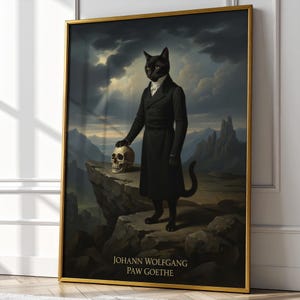 May include: A framed art print featuring a black cat in a black coat, holding a skull on a rocky cliff. The background shows a dramatic sky and mountains. The print has gold trim and the text "JOHANN WOLFGANG PAW GOETHE".