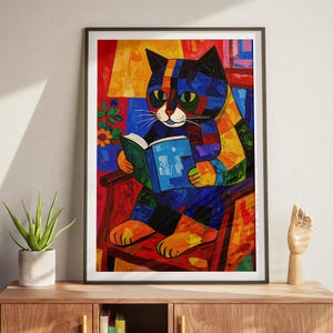 May include: A colorful, abstract painting of a cat reading a book. The cat is depicted in a patchwork style, with vibrant blues, yellows, and reds. The cat is seated in a wooden chair, holding a blue book. The background features a window and a lamp.