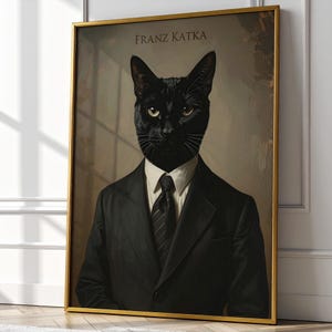 May include: Framed art print featuring a black cat with yellow eyes, dressed in a black suit, white shirt, and striped tie. The print has a gold frame and the text "FRANZ KATKA" at the top. The artwork has a vintage, portrait style.
