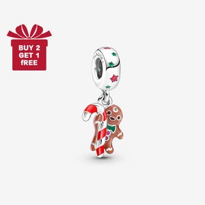 May include: A silver charm with a candy cane and gingerbread man pendant. The charm has a cylindrical top with red and green star accents. The candy cane is red and white striped, and the gingerbread man is brown with a green bow tie.