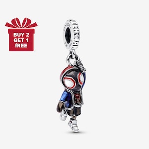 May include: A silver charm featuring a cartoon character in a red and black mask, blue jacket, and white sneakers. The charm is suspended from a ring with the word "PANDORA" on it. A red gift box with the text "BUY 2 GET 1 FREE" is in the upper left corner.