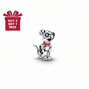 May include: A silver-colored Dalmatian dog charm with black spots and a red collar. The charm is sitting down and has a detailed design. A red gift box with a bow and the text "BUY 2 GET 1 FREE" is in the upper left corner.