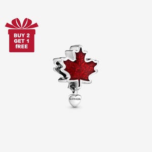 May include: A silver charm with a red maple leaf design. The charm has a heart-shaped pendant that says "CANADA". A red gift box with the text "BUY 2 GET 1 FREE" is in the upper left corner.