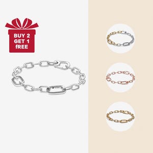 May include: A silver chain bracelet featuring oval and rectangular links. The image also shows three other bracelets in gold, rose gold, and a gold and silver combination. A red graphic with the text "BUY 2 GET 1 FREE" is in the upper left corner.