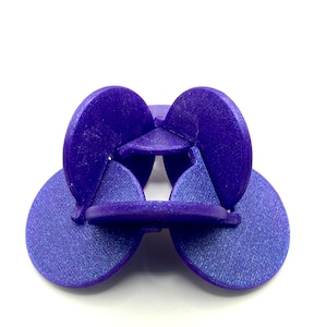 May include: A purple interlocking puzzle made of six pieces. Each piece is a rounded shape with a slight curve. The pieces are connected to form a three-dimensional shape.