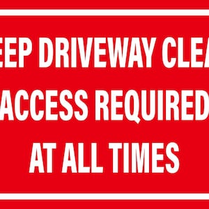 May include: A red rectangular sign with white text and a white border. The text reads "KEEP DRIVEWAY CLEAR ACCESS REQUIRED AT ALL TIMES". The sign is designed to be easily visible and convey an important message.