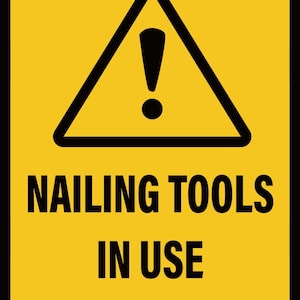 May include: Yellow rectangular sign with black text and a black triangle containing an exclamation mark. The text reads: NAILING TOOLS IN USE KEEP CLEAR. The sign is a warning about the use of tools.