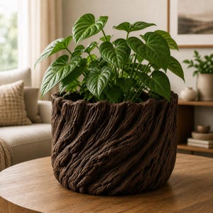 May include: A large, dark brown planter with a textured, wood-like appearance, filled with vibrant green heart-shaped leaves. The planter sits on a wooden table, creating a natural, earthy aesthetic. The plant is a lush, decorative houseplant.