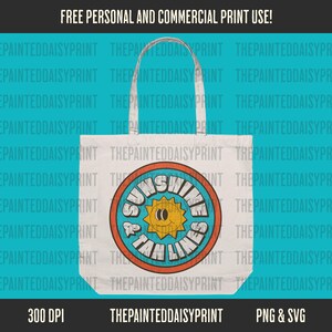 May include: A white tote bag with a blue, orange, and yellow graphic design that says "Sunshine & Tan Lines".